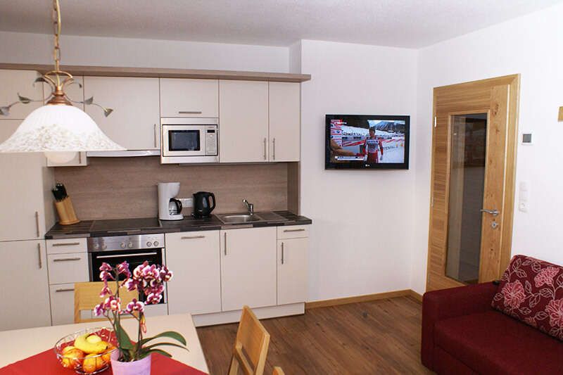 Kitchen and living area in apartment 1 in Apart Wolf
